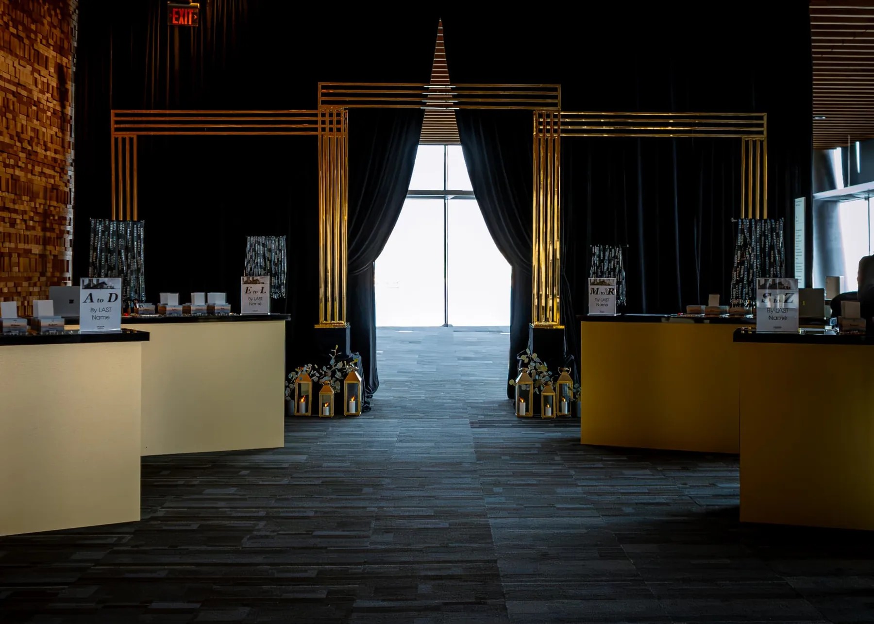 Gold entrance arch with black velour drapery and lanterns at the Fasken reception, Vancouver Convention Centre