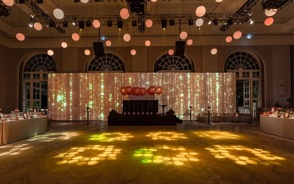 Ballroom with suspended sphere lights and projection backdrop
