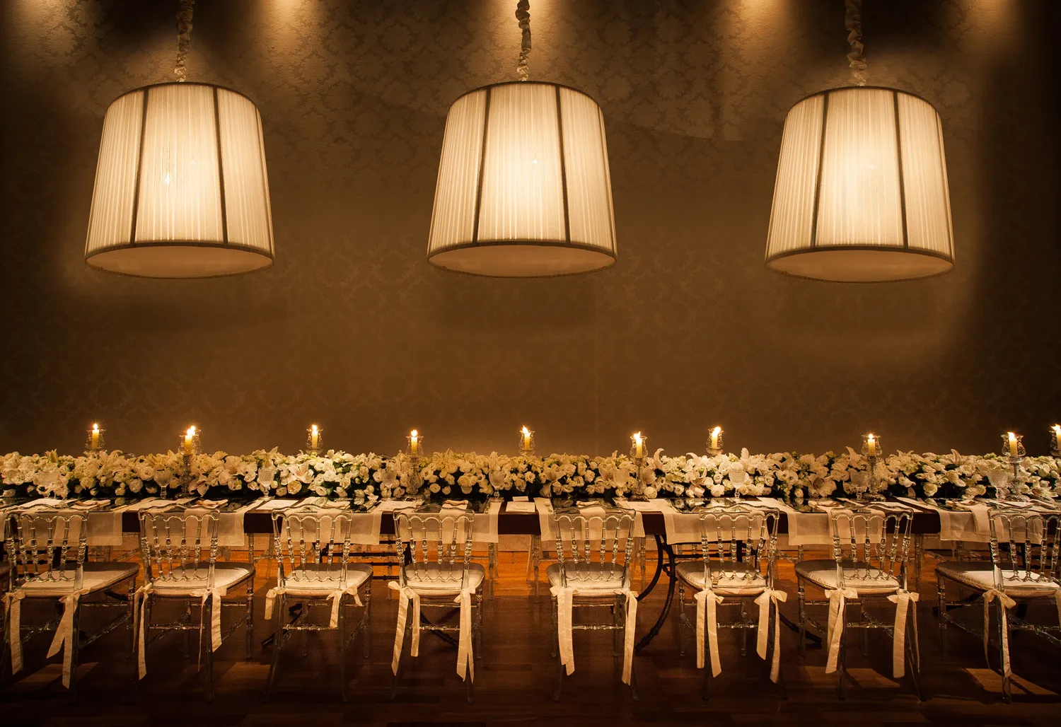 Banquet table with white florals and crystal chairs