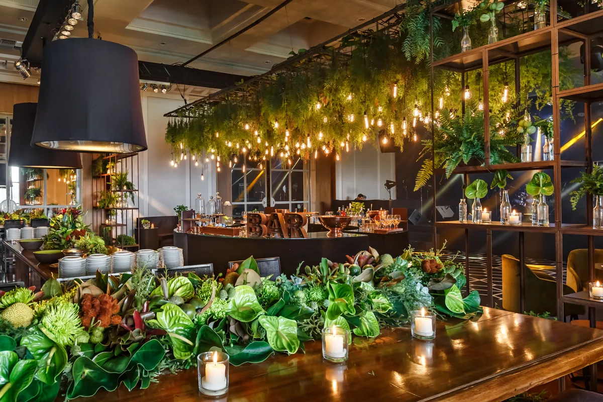 Tropical bar with hanging foliage and Edison bulbs